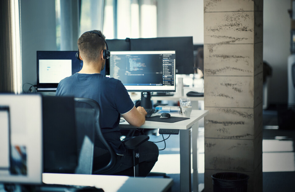 Guy at Computer with Headphones